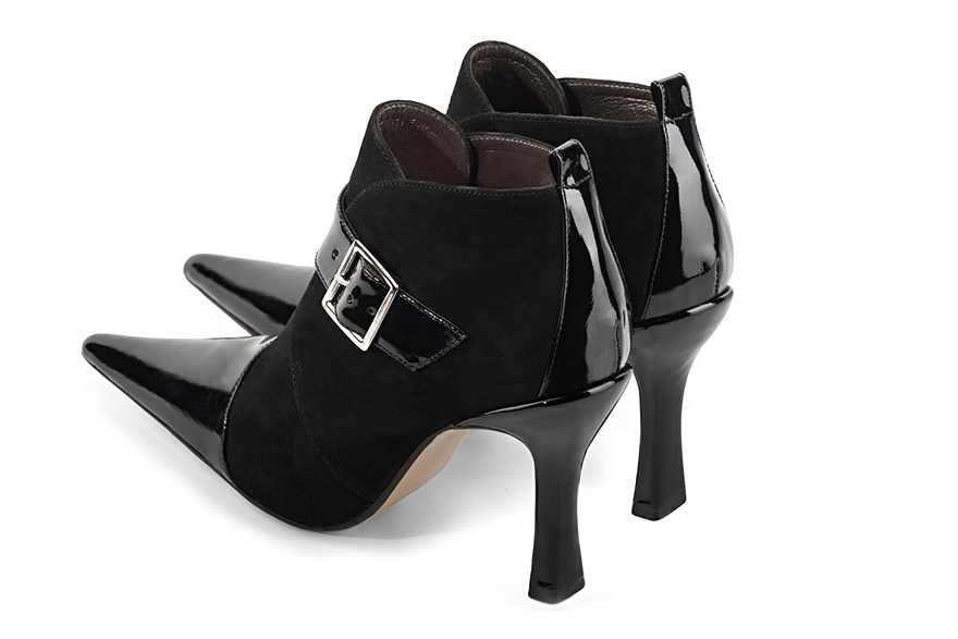 Gloss black women's ankle boots with buckles at the front. Pointed toe. Very high spool heels. Rear view - Florence KOOIJMAN